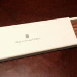 Graf von Faber-Castell white pencil box on wooden desk with logo on lid