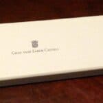Graf von Faber-Castell branded white pencil box on wooden surface with crown logo and text