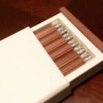 Brown Graf von Faber-Castell No.III desk pencils neatly arranged in white box on wooden surface