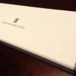 Graf von Faber-Castell branded white pencil box on dark wooden surface
