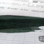 Diamine Green Black fountain pen ink swatch on lined paper showing shading and saturation