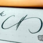Close-up of cursive writing using Diamine Green/Black fountain pen ink on paper
