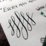 Diamine Green Black ink calligraphy swirls on white paper with handwritten text