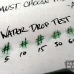 Diamine Green Black ink water drop test showing colour fading and smudging on paper