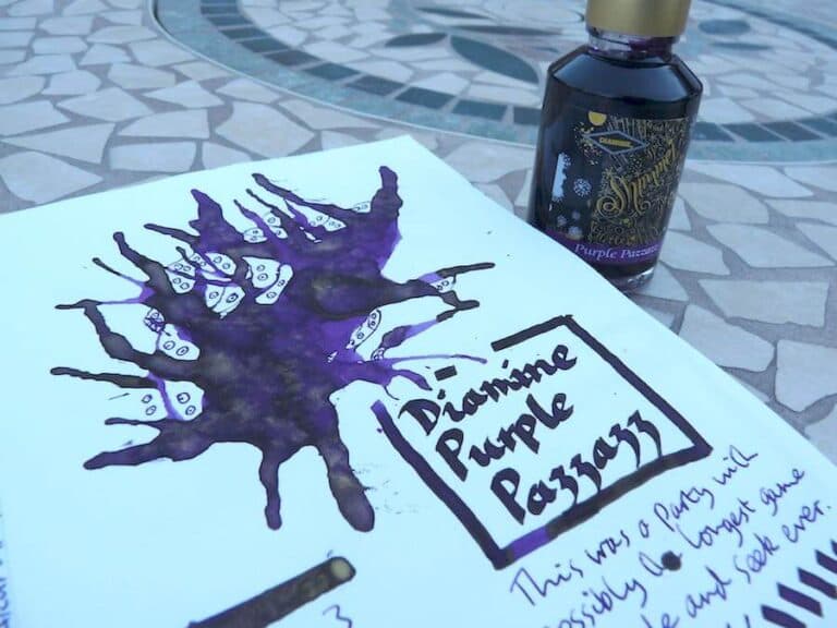 Diamine Purple Pazzazz Shimmertastic ink bottle with purple ink swatch and handwritten notes