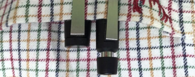 Two Lamy 2000 mechanical pencils with brushed metal clips on checkered fabric