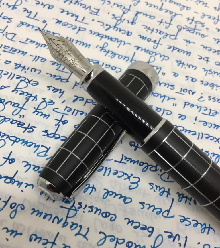 Diplomat Excellence Rhombus black fountain pen with silver grid pattern on handwritten blue ink text