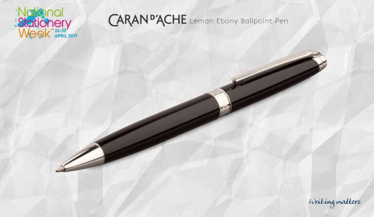 Caran d'Ache Leman Ebony ballpoint pen with silver trim on textured grey background