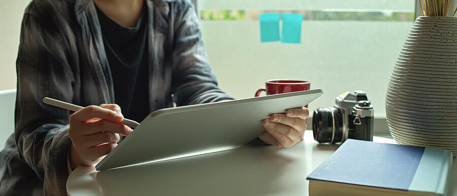 An artist using a stylus on a tablet.