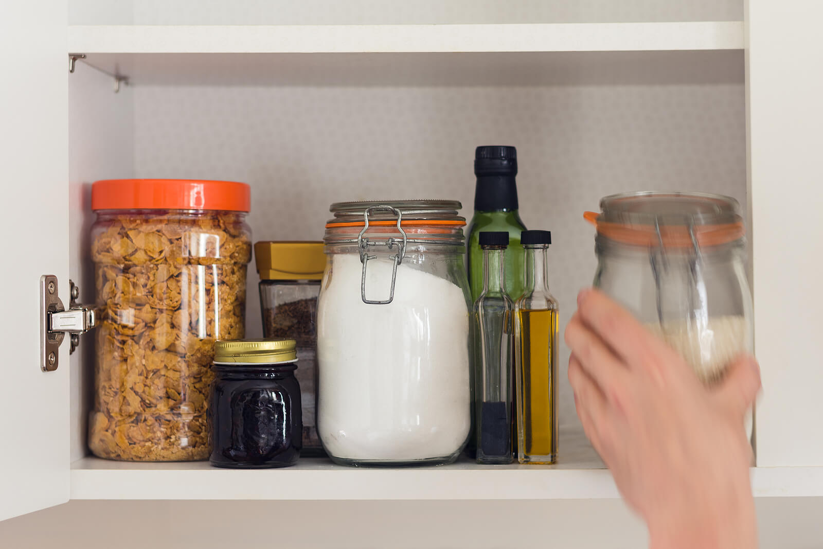 jars and containers of cereals jam coffee sugar flour oil vinegar rice in pantry