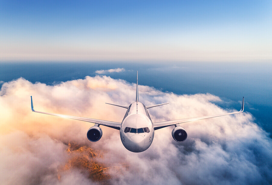 an airplane in the sky surrounded by clouds