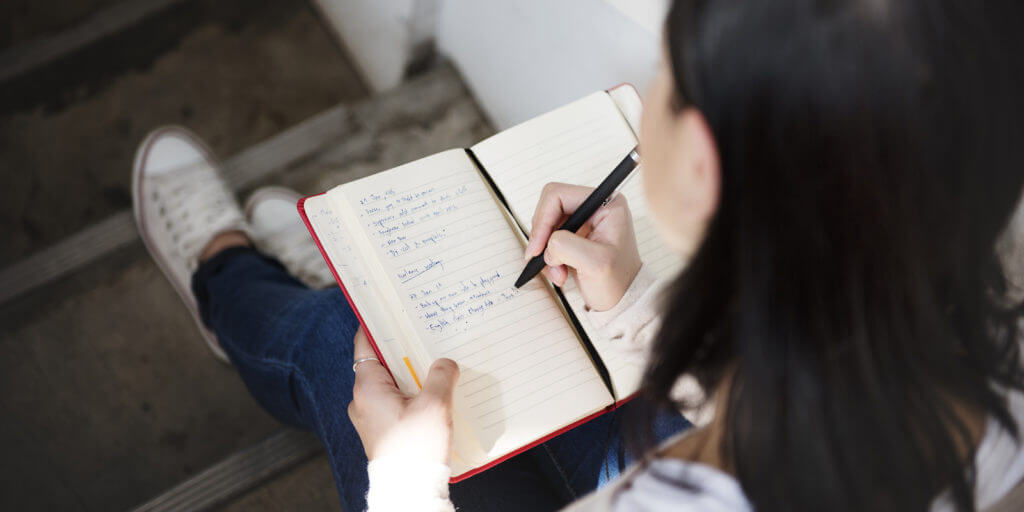 A woman writing in a journal