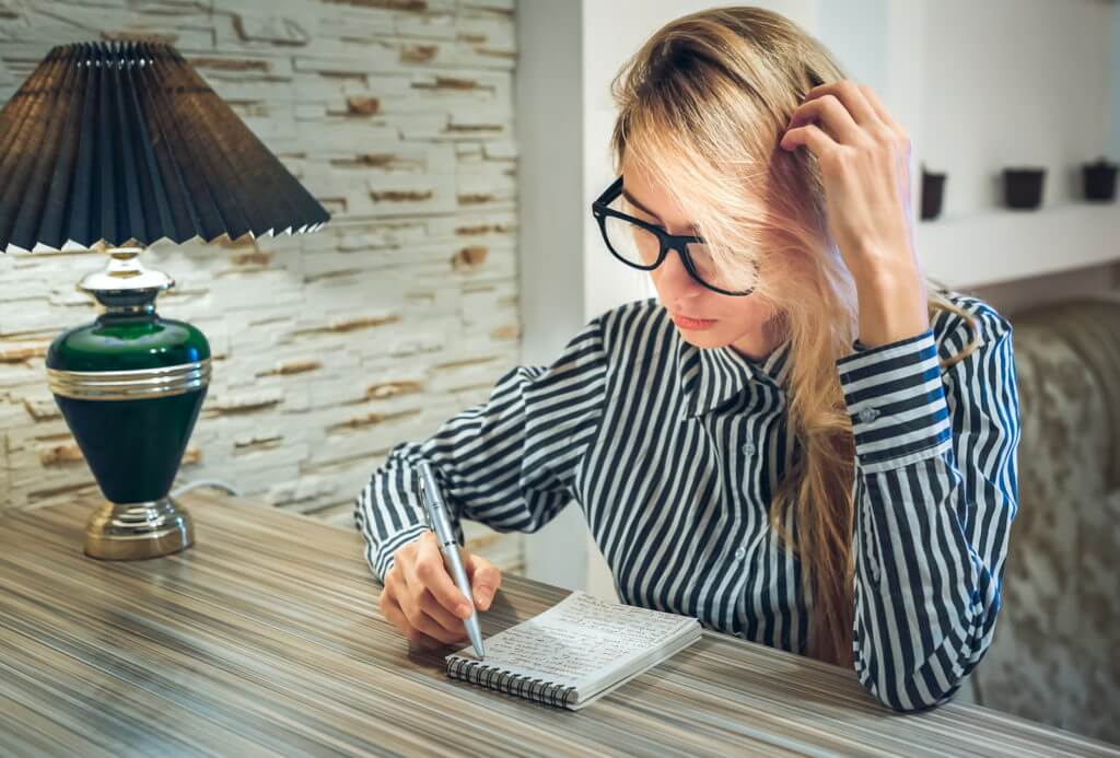 A woman writing a ballad poem
