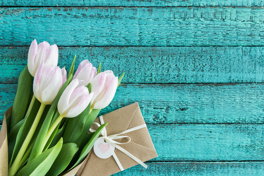 Envelope with tulips on a table