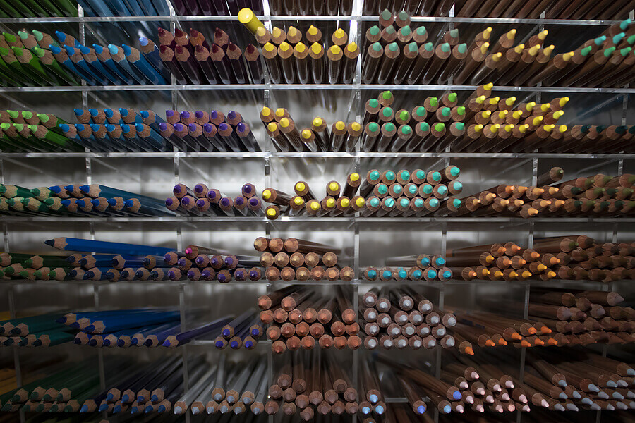 Multicolored Pencils Arranged by Color in Cells on the Shelf of the Stationery Store.
