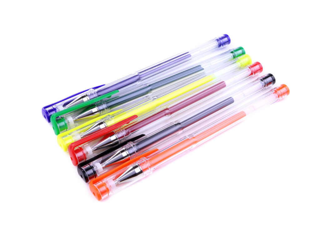 A set of colourful gel pens against a white background