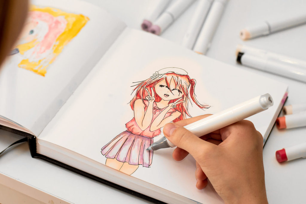 Close-up of a hand drawing manga