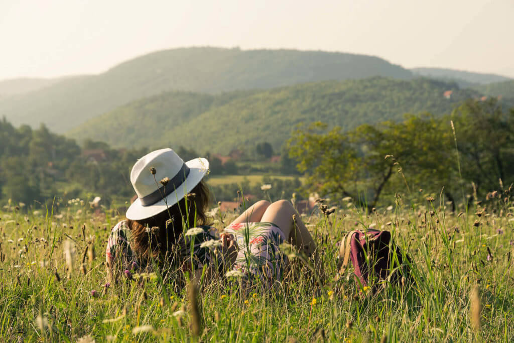 A woman on holiday or vacation, sat in the countryside