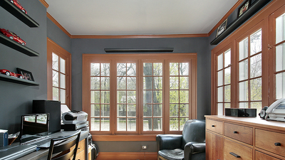 Home office with wall of windows around room